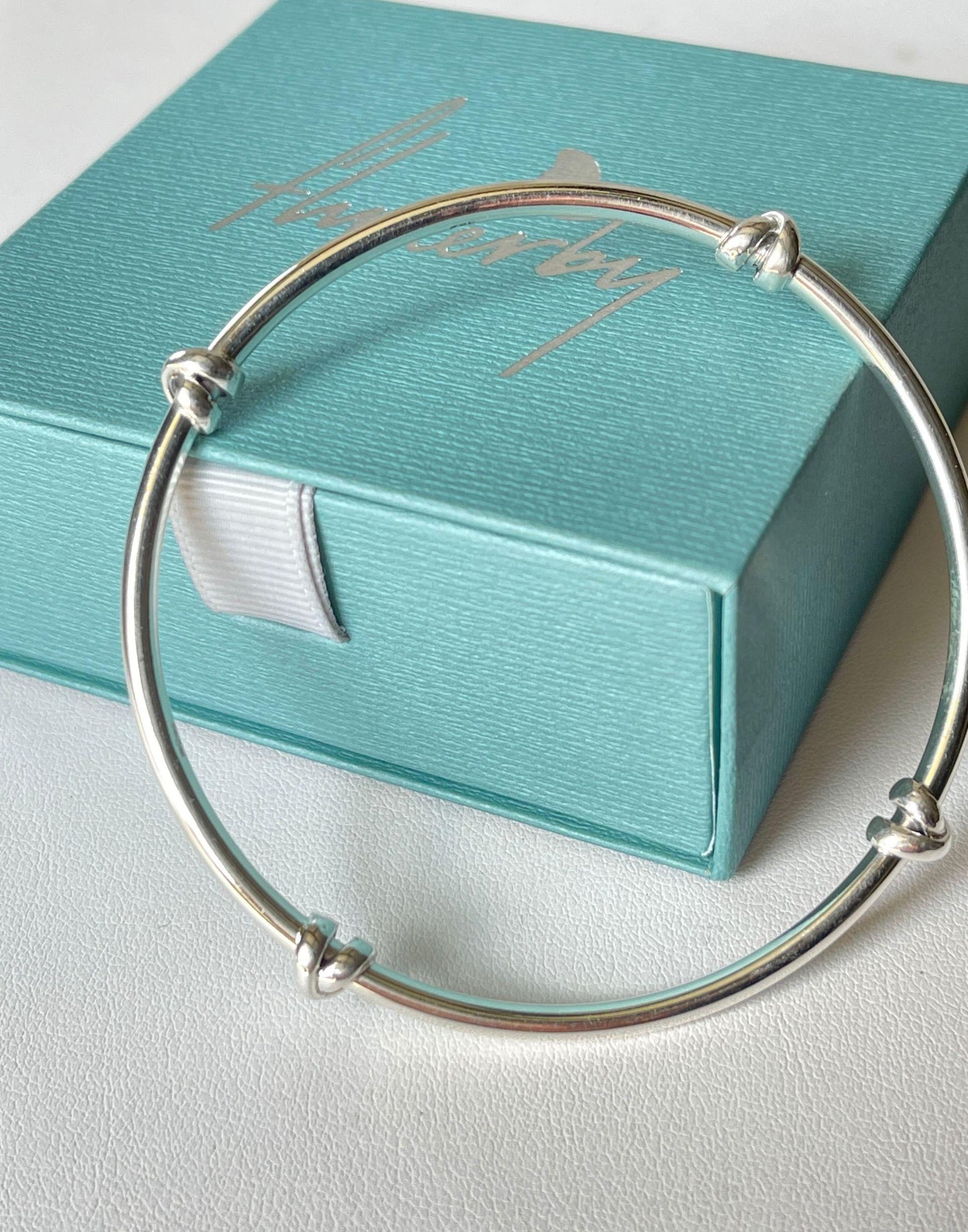  morton silver knot bangle resting on Flutterby gift box