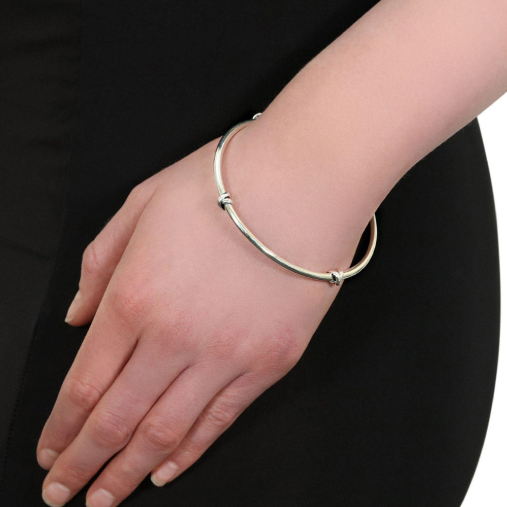 
                  
                    Model wears morton silver knot bangle
                  
                