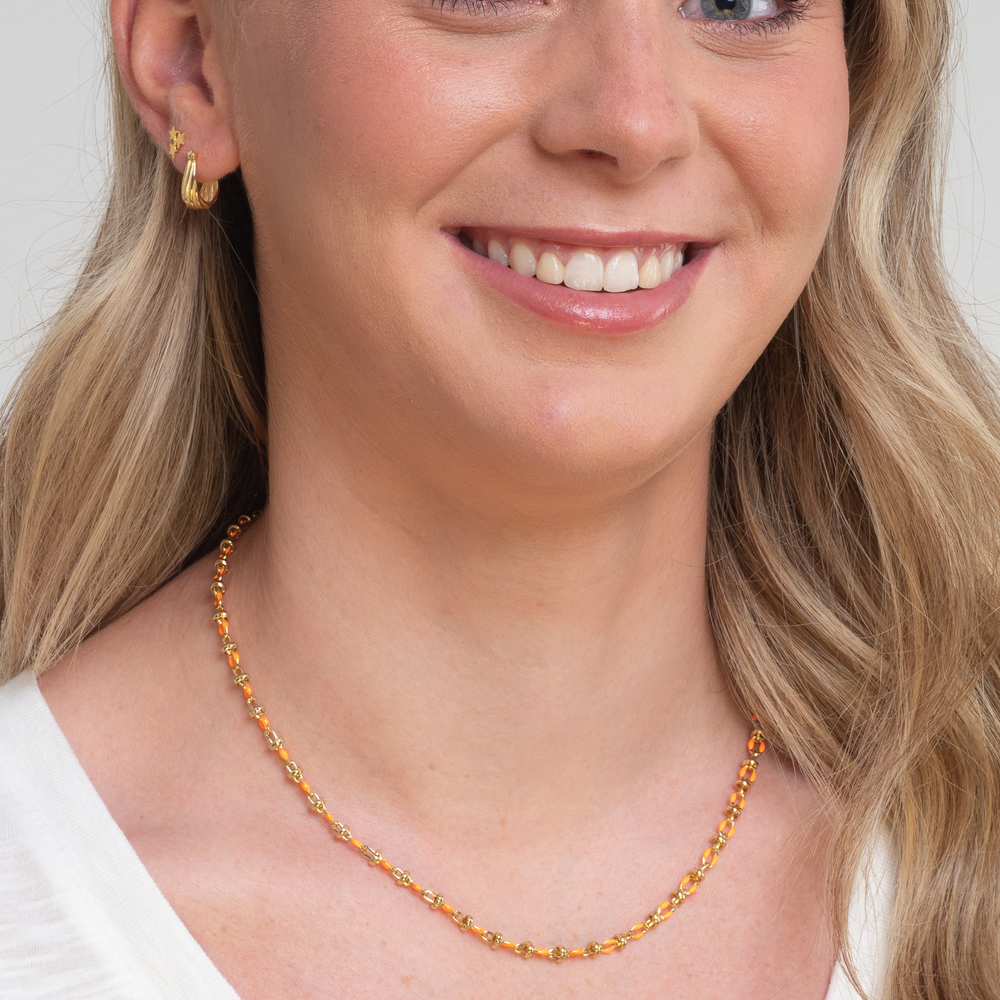 orange enamel necklace on model