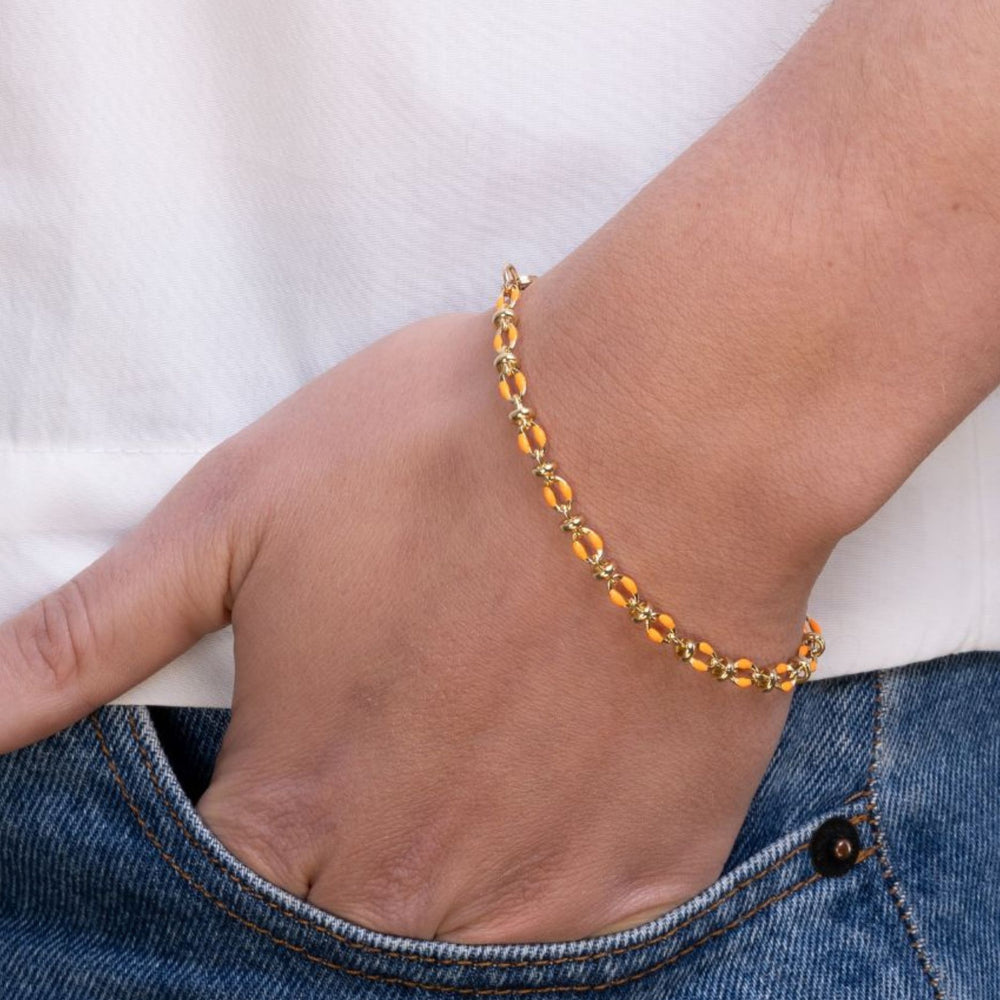 
                  
                    Model wears orange enamel bracelet
                  
                