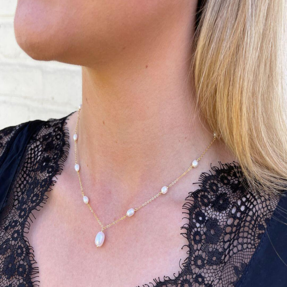 
                  
                    pearl drop necklace on model
                  
                