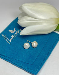 Freshwater pearl stud earrings on a Flutterby Gift Pouch with a tulip