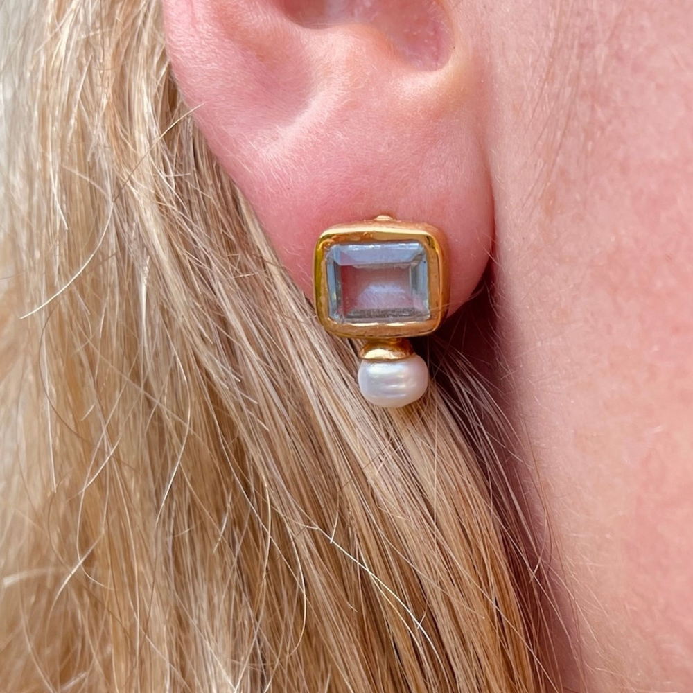 
                  
                    pearl and blue topaz stud earrings on model
                  
                