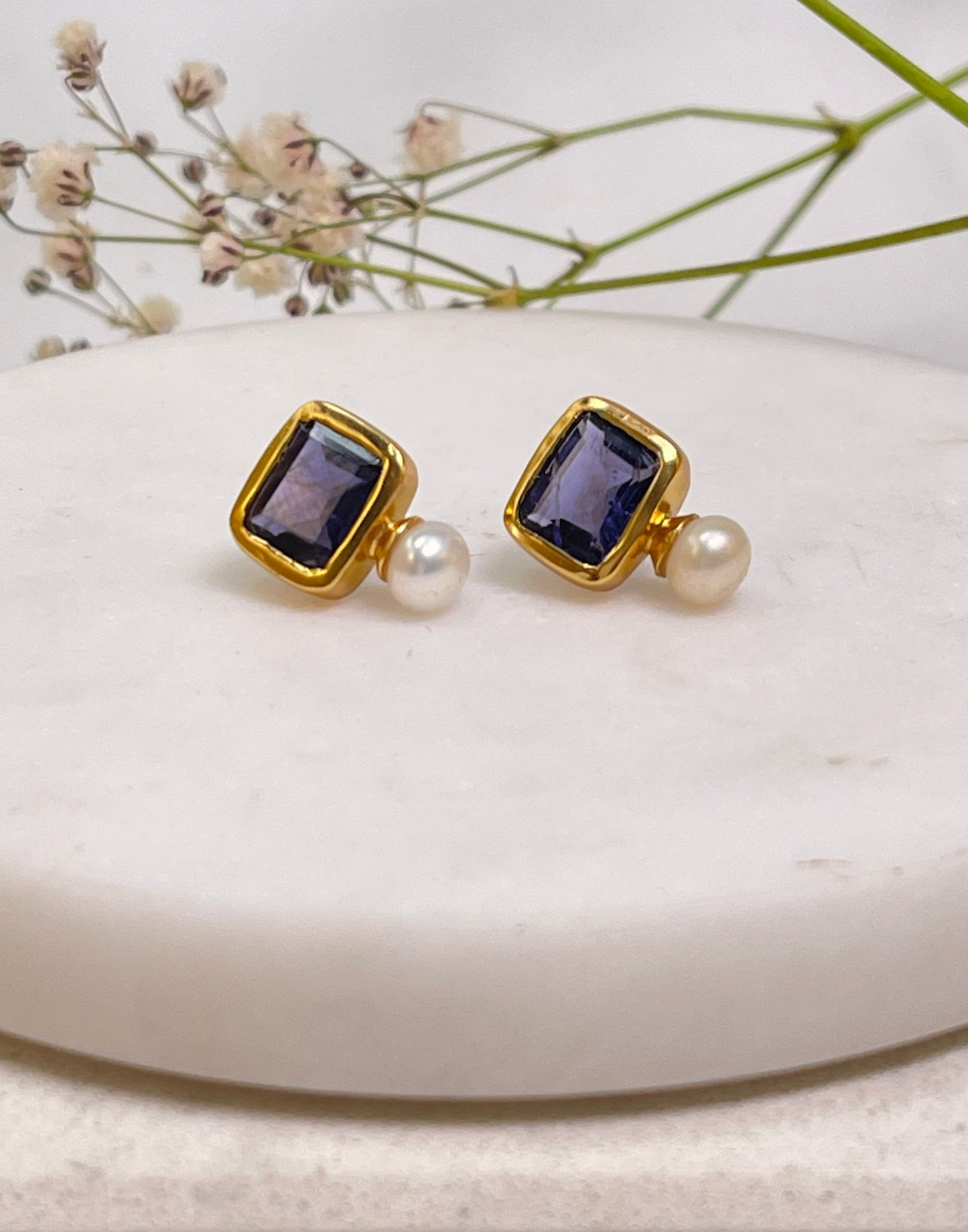 pearl and iolite stud earrings on tile