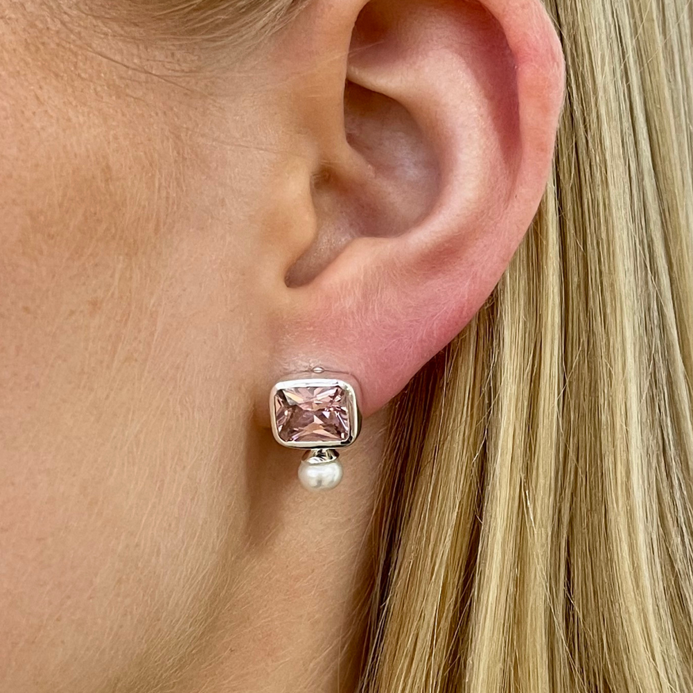 pink and pearl stud earrings on model