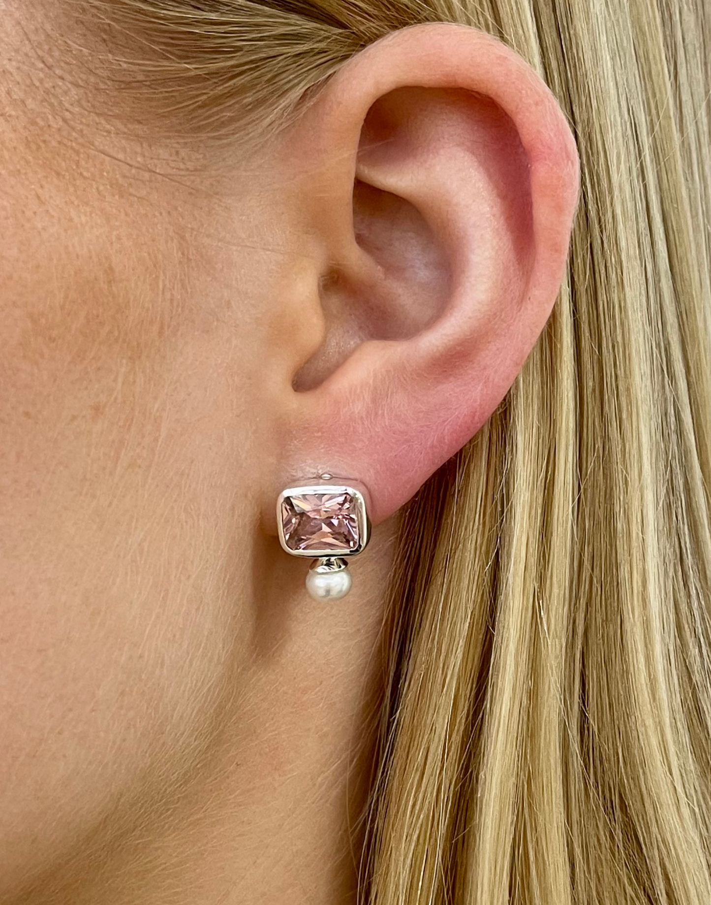 pink and pearl stud earrings on model