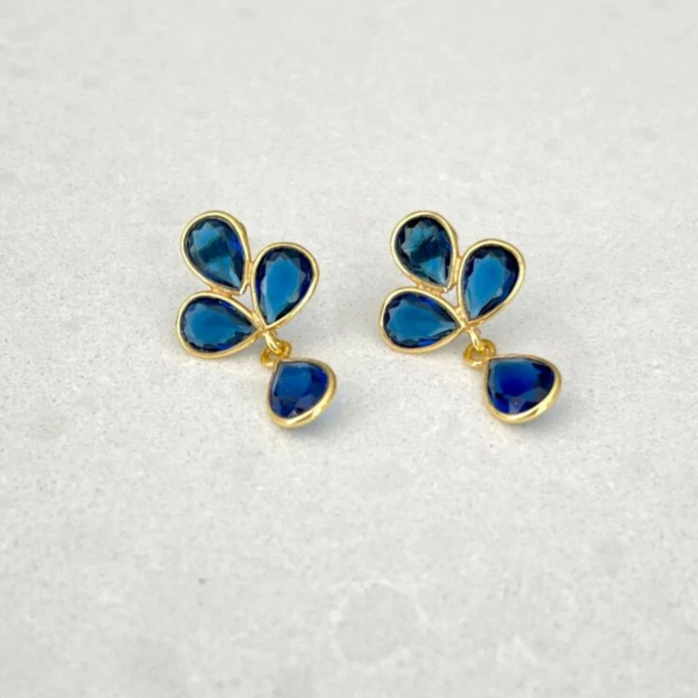 
                  
                    Petal Dark Blue Topaz Gold Earrings on tile
                  
                