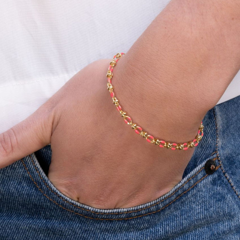 Model wears pink enamel bracelet