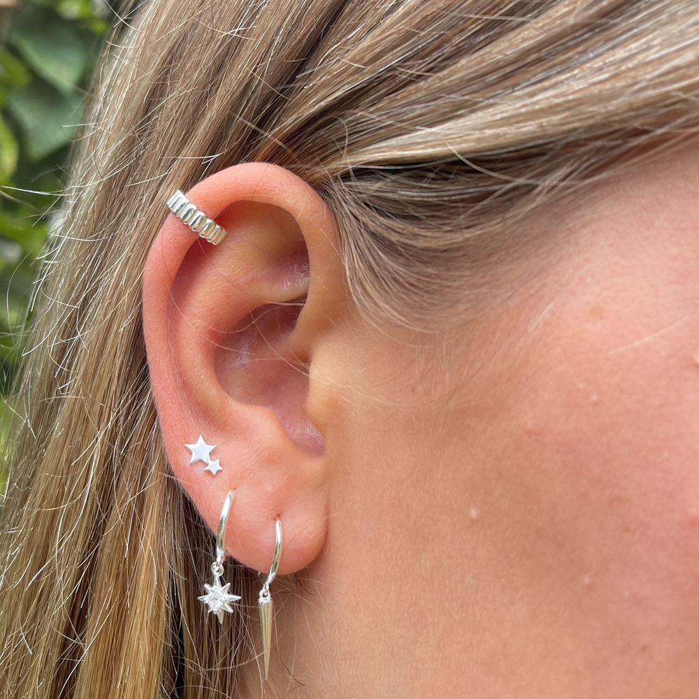 model wearing ridged silver ear cuff