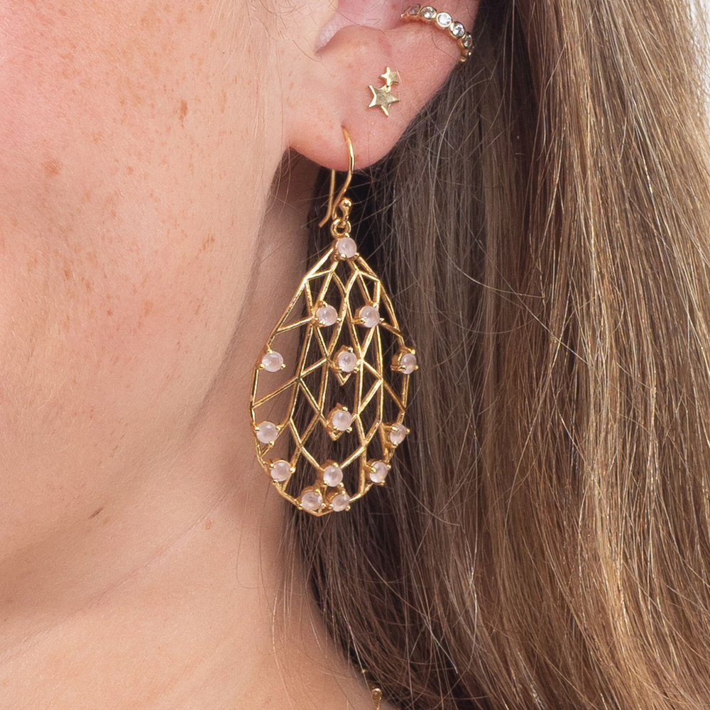 rose quartz pearl drop earrings in ear