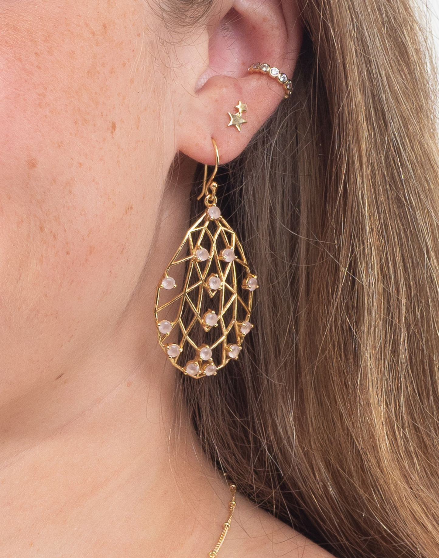 rose quartz pearl drop earrings in ear