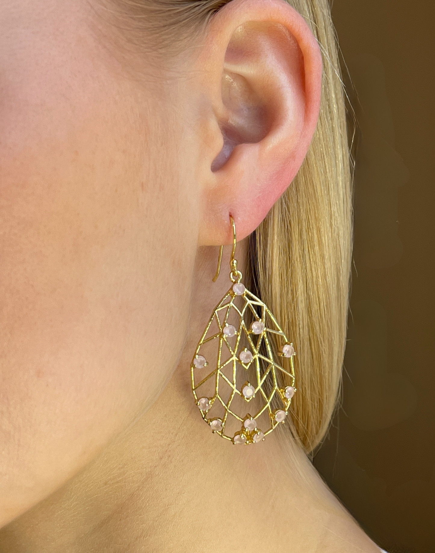 model wears rose quartz pear drop earrings