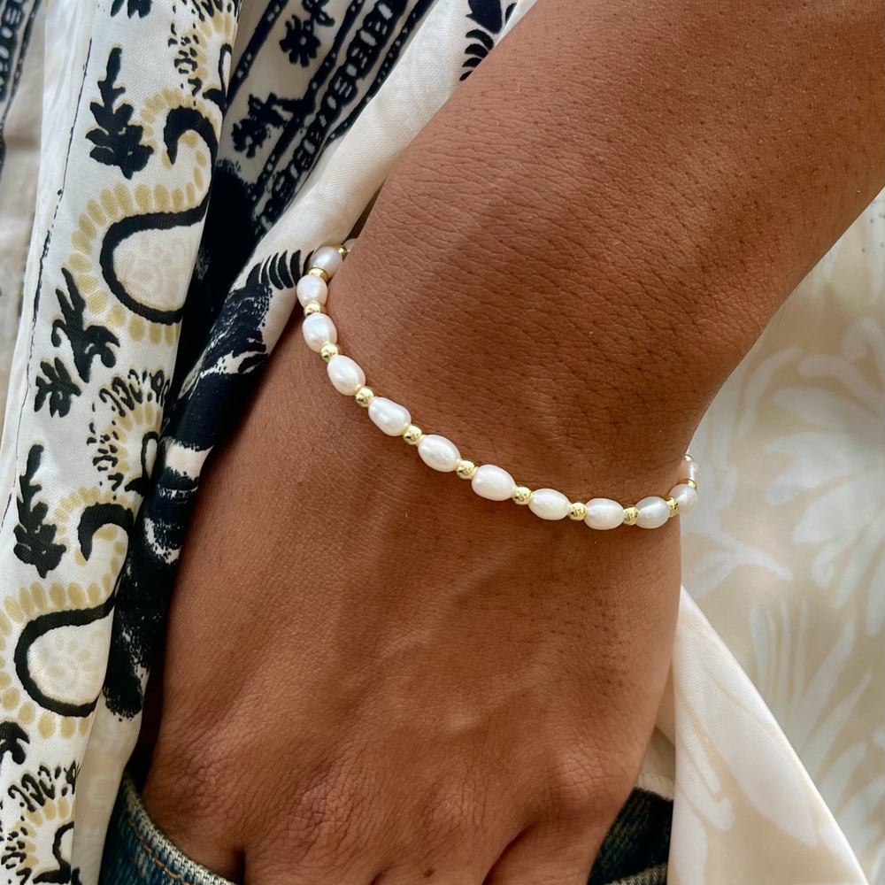 Model wears Sadie pearl and gold bracelet