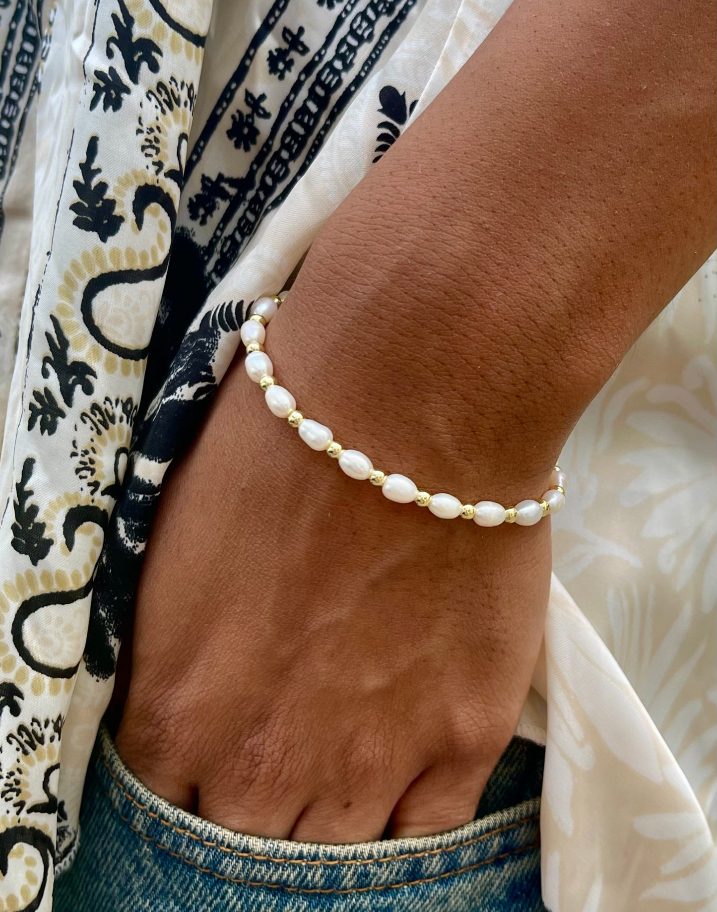 Model wears Sadie pearl and gold bracelet