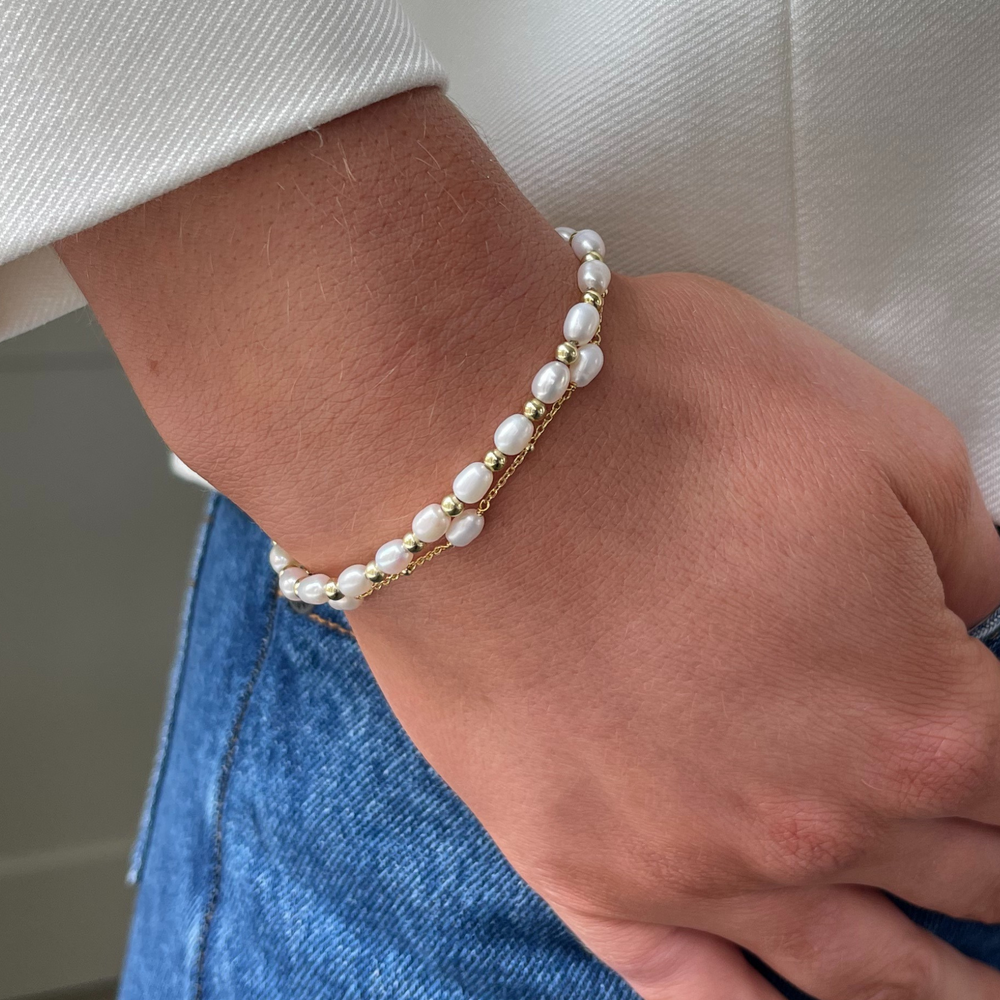 
                  
                    Model wears Sadie pearl and gold bracelet stacked with Helena gold and pearl bracelet
                  
                
