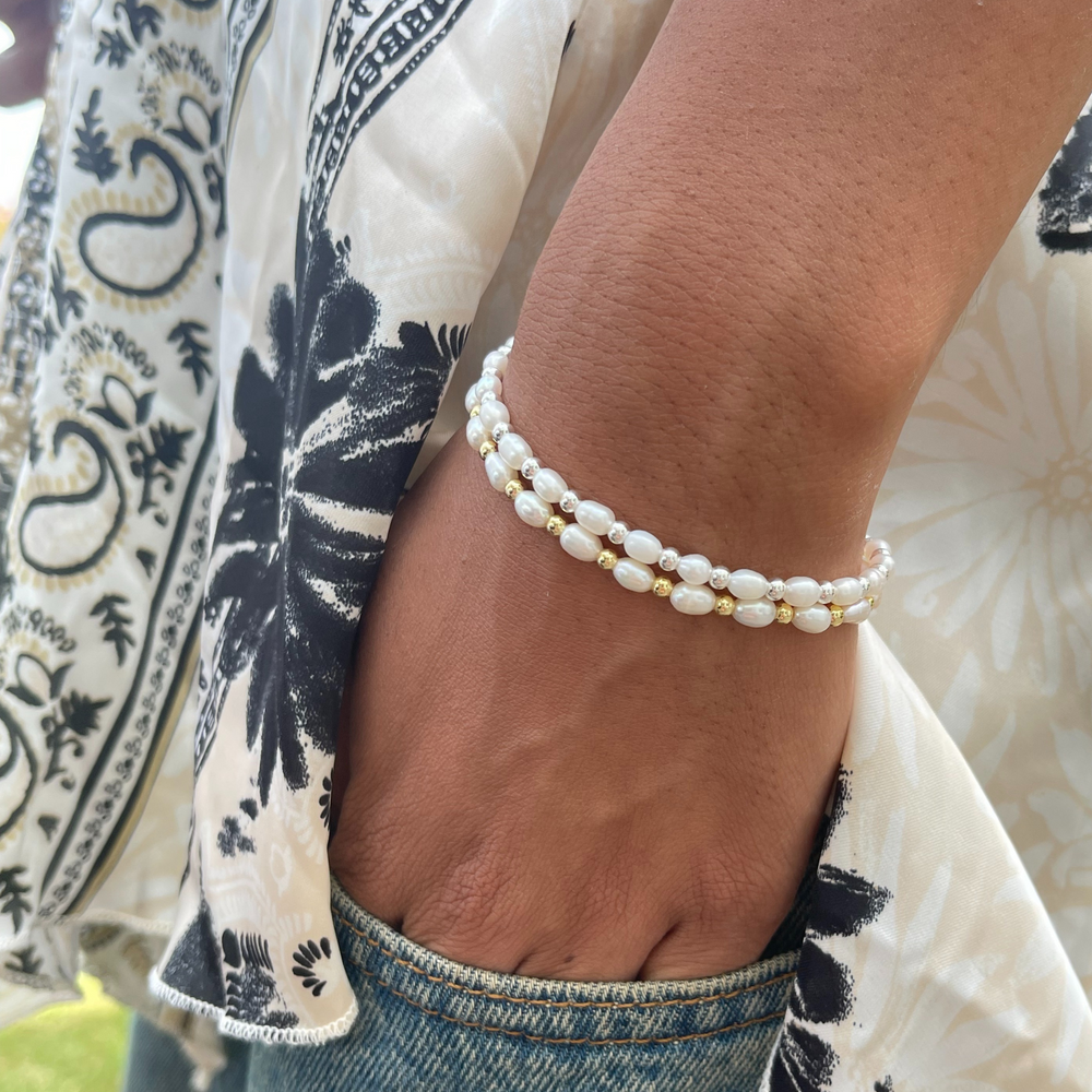 
                  
                    Model wears Sadie pearl and gold bracelet and Sadie pearl and silver bracelet, stacked
                  
                