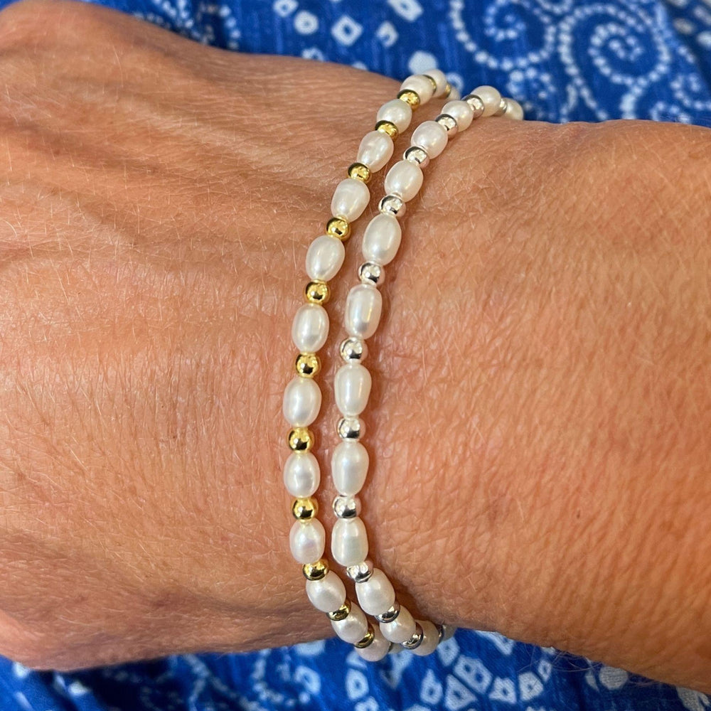 
                  
                    Model wears Sadie Pearl and Silver Bracelet and Sadie Pearl and Gold Bracelet
                  
                