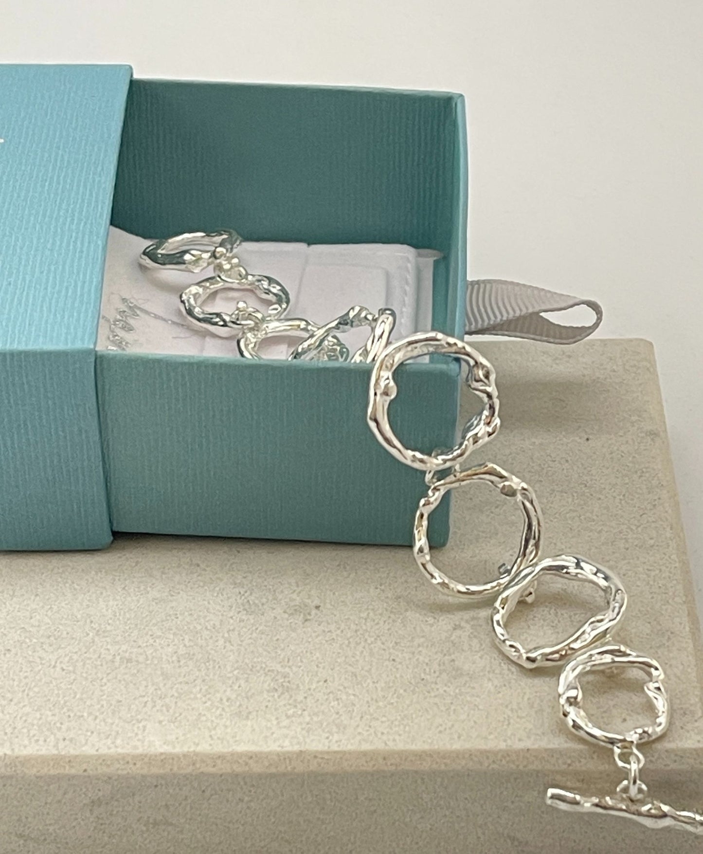 Stylish Chole Sterling Silver Bracelet on a tile