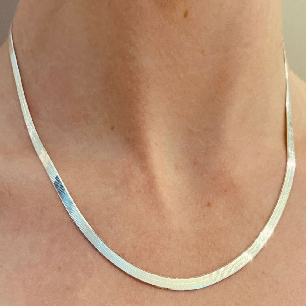 silver herringbone necklace on model