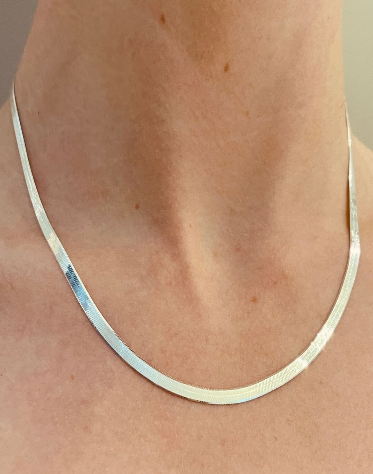 silver herringbone necklace on model