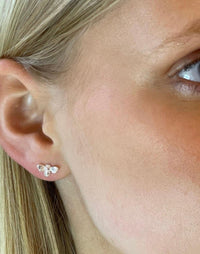 model wears silver bee stud earrings