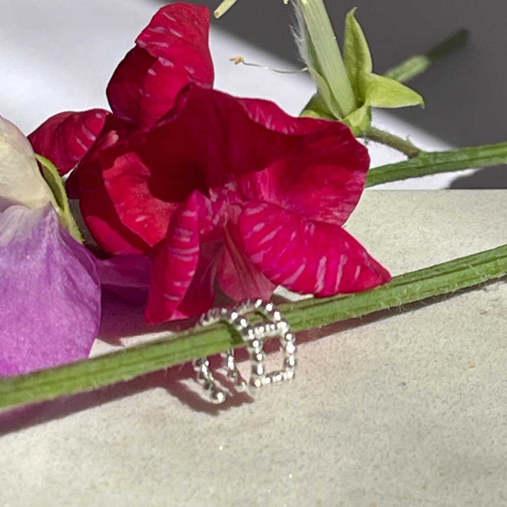 
                  
                    silver double row bobble ear cuff in flower
                  
                
