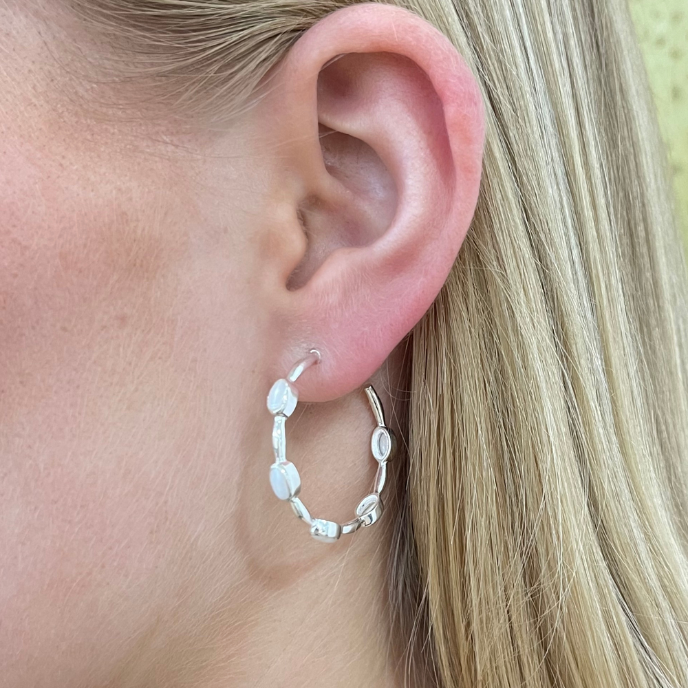 silver pearl hoop earrings on model
