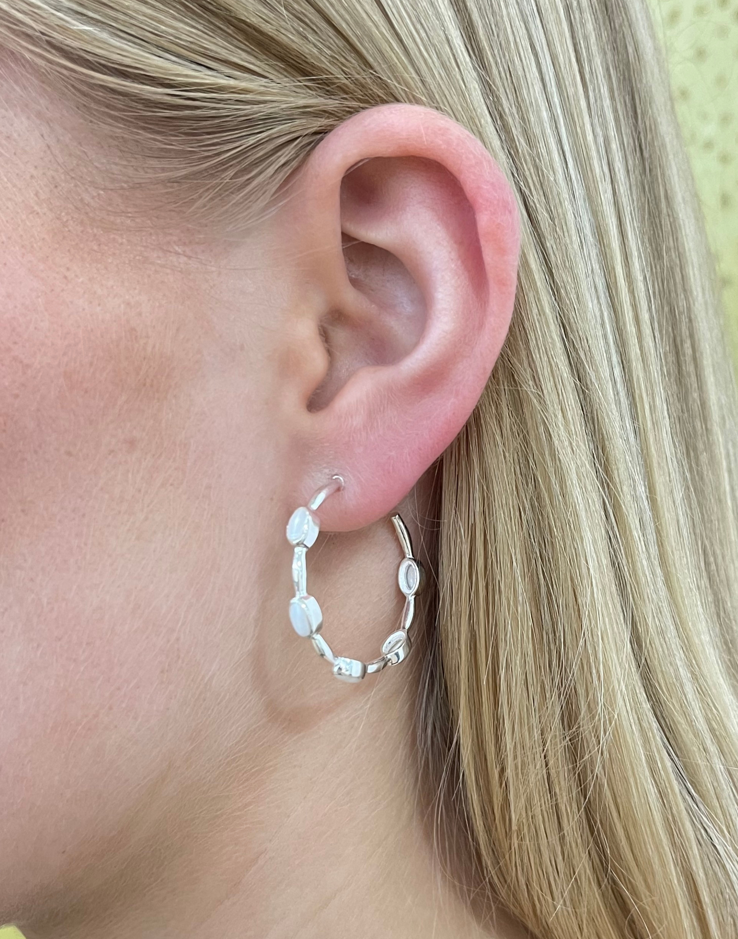 silver pearl hoop earrings on model