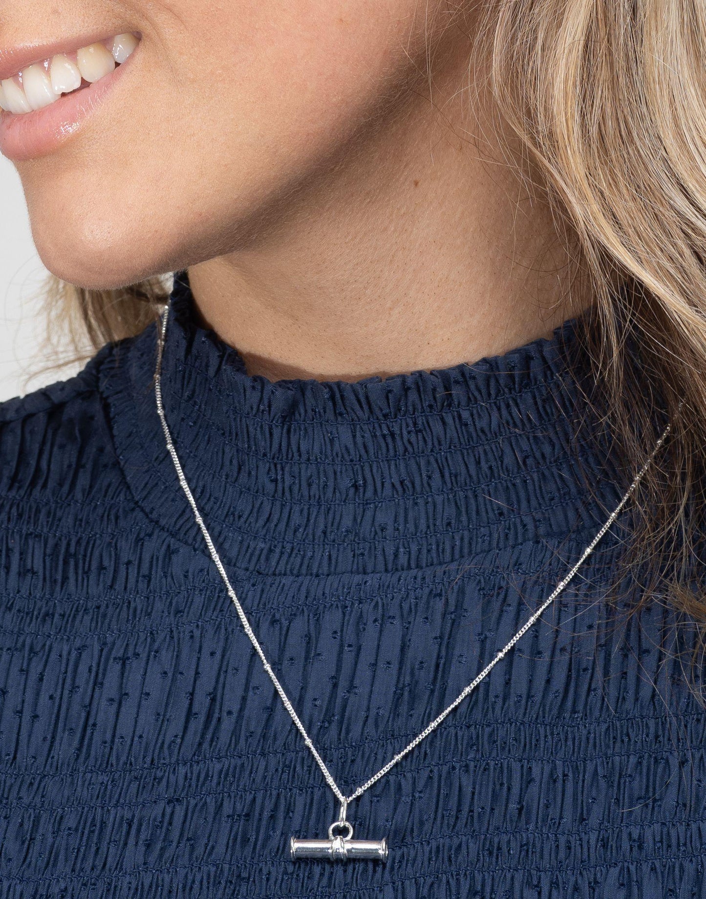 Model wears silver t bar necklace