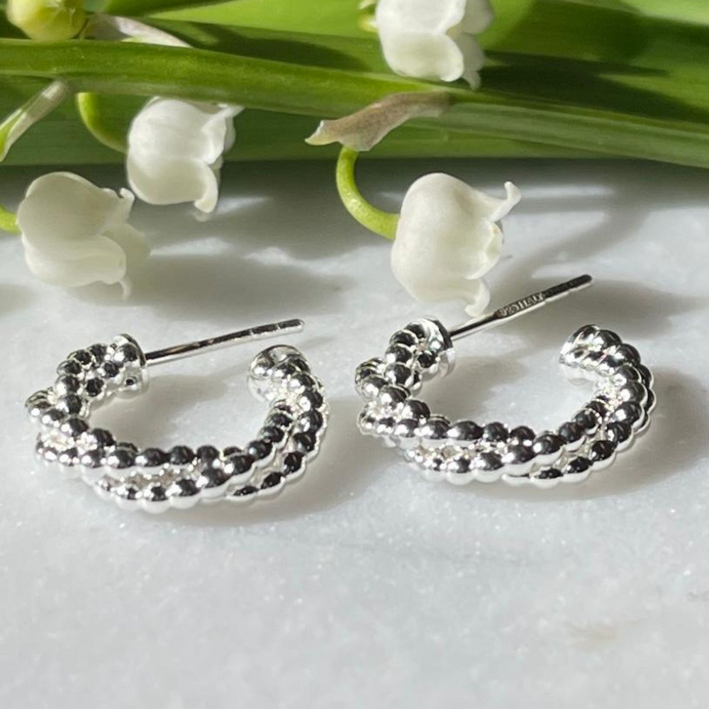 
                  
                    Silver twisted bead hoop earrings
                  
                
