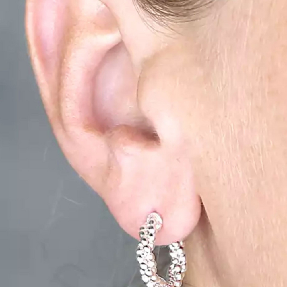 silver twisted bead hoop earrings on model