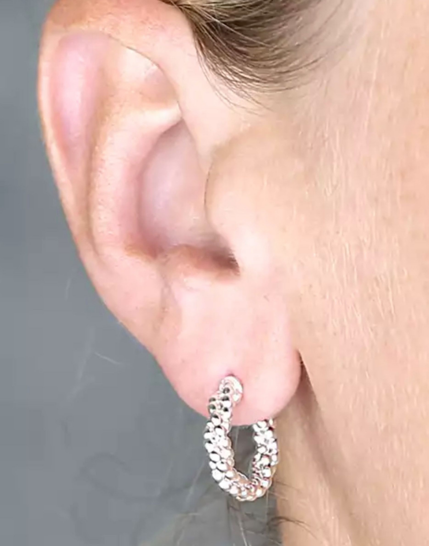 silver twisted bead hoop earrings on model