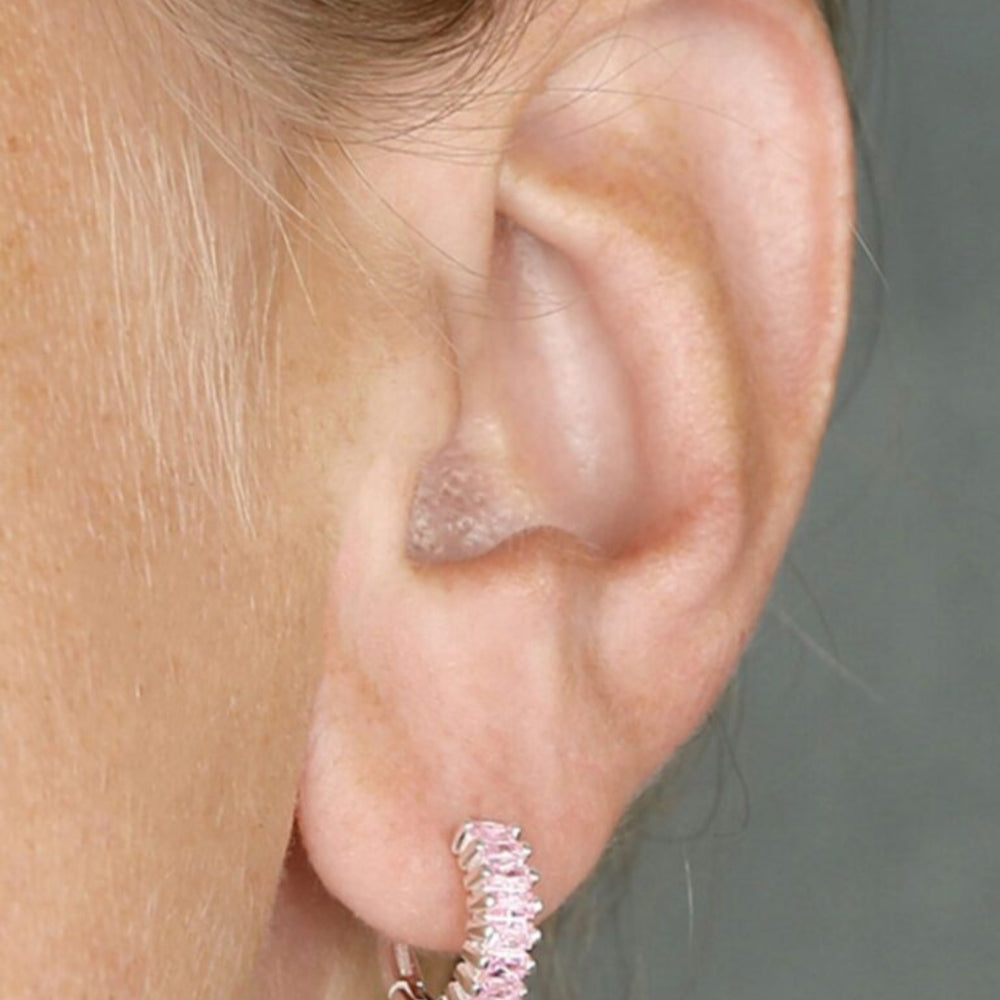 Silver and pale pink holiday huggies on model