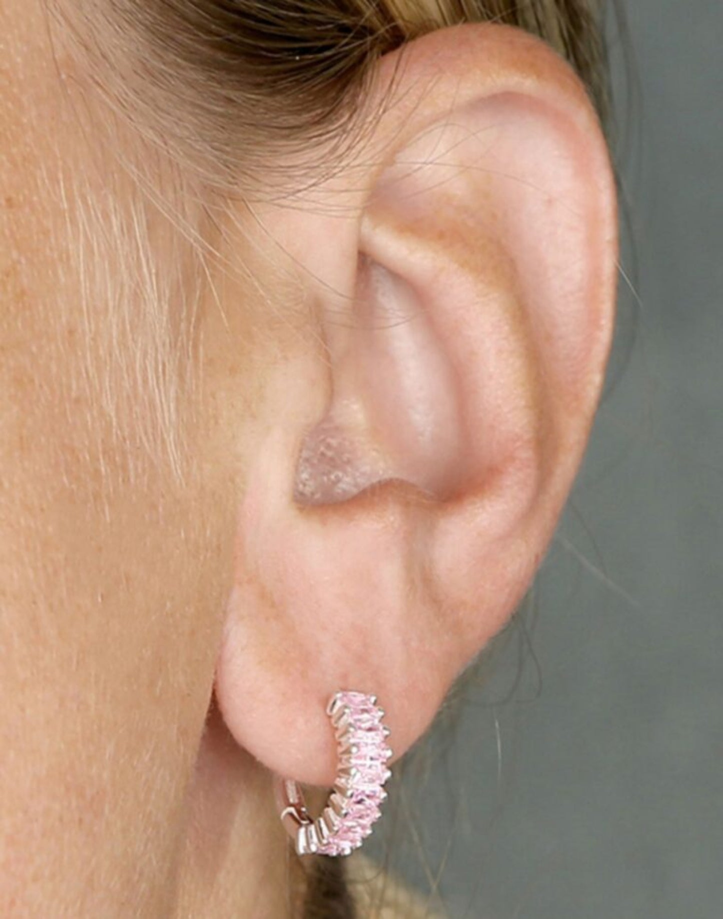 Silver and pale pink holiday huggies on model