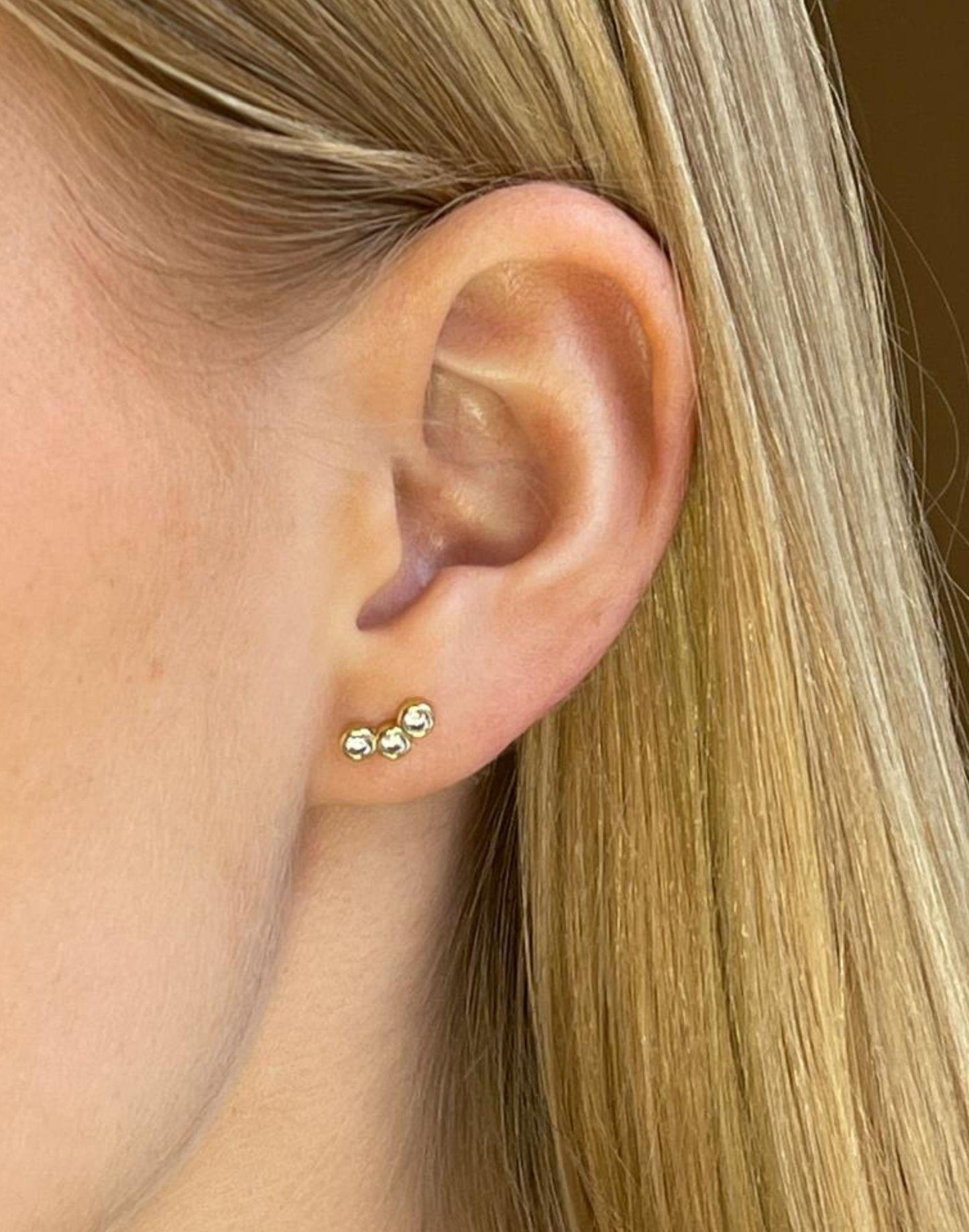 model wears triple cZ Gold stud