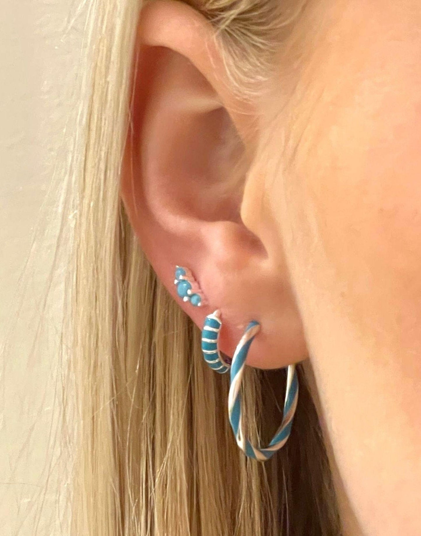 Turquoise stripy earring stack in models ear