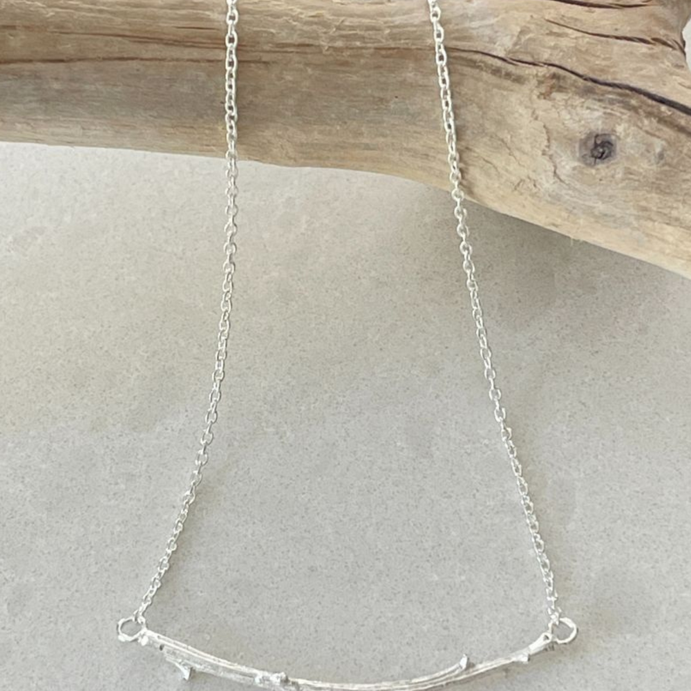 Silver Twig necklace on branch