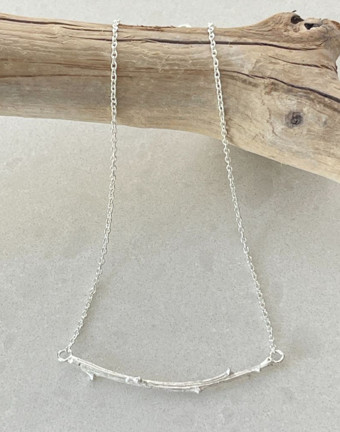Silver Twig necklace on branch