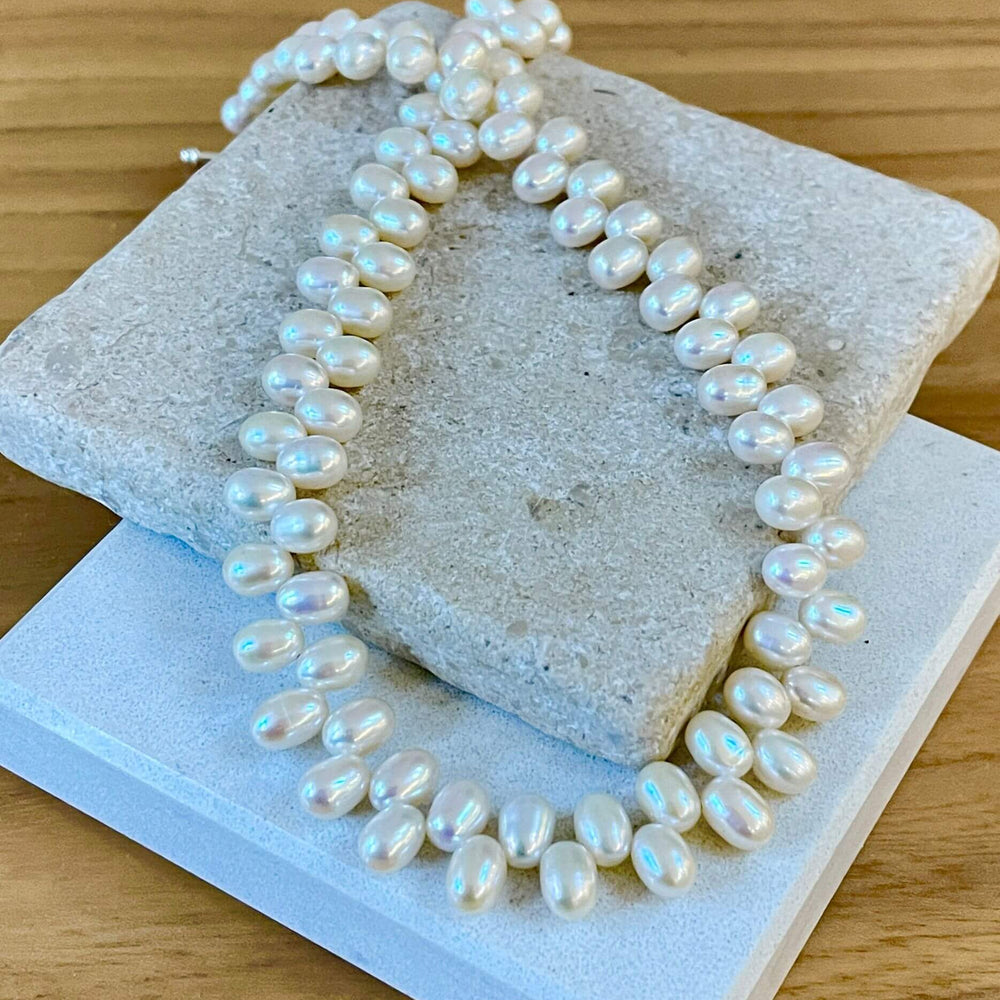 unusual pearl necklace on tiles