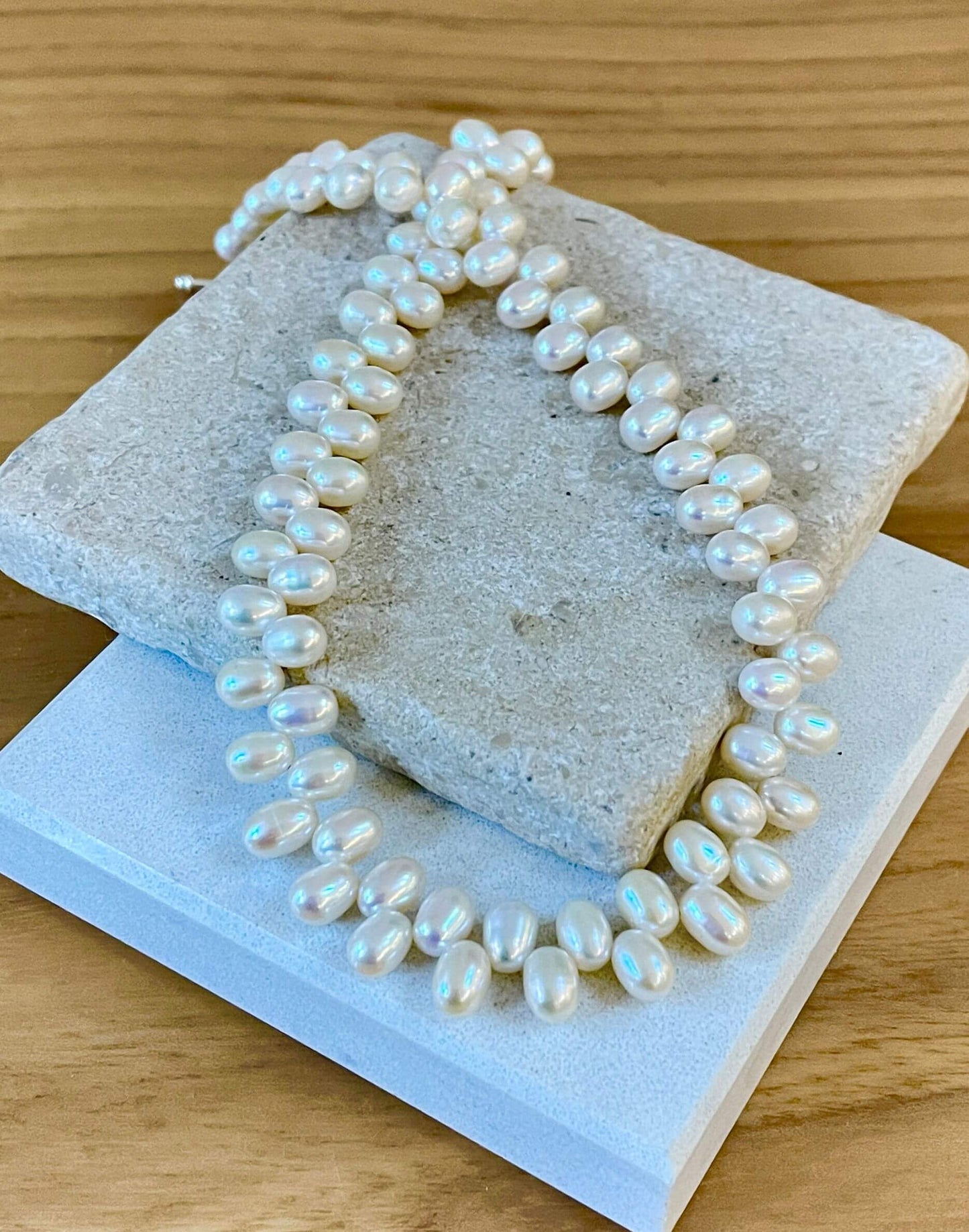 unusual pearl necklace on tiles
