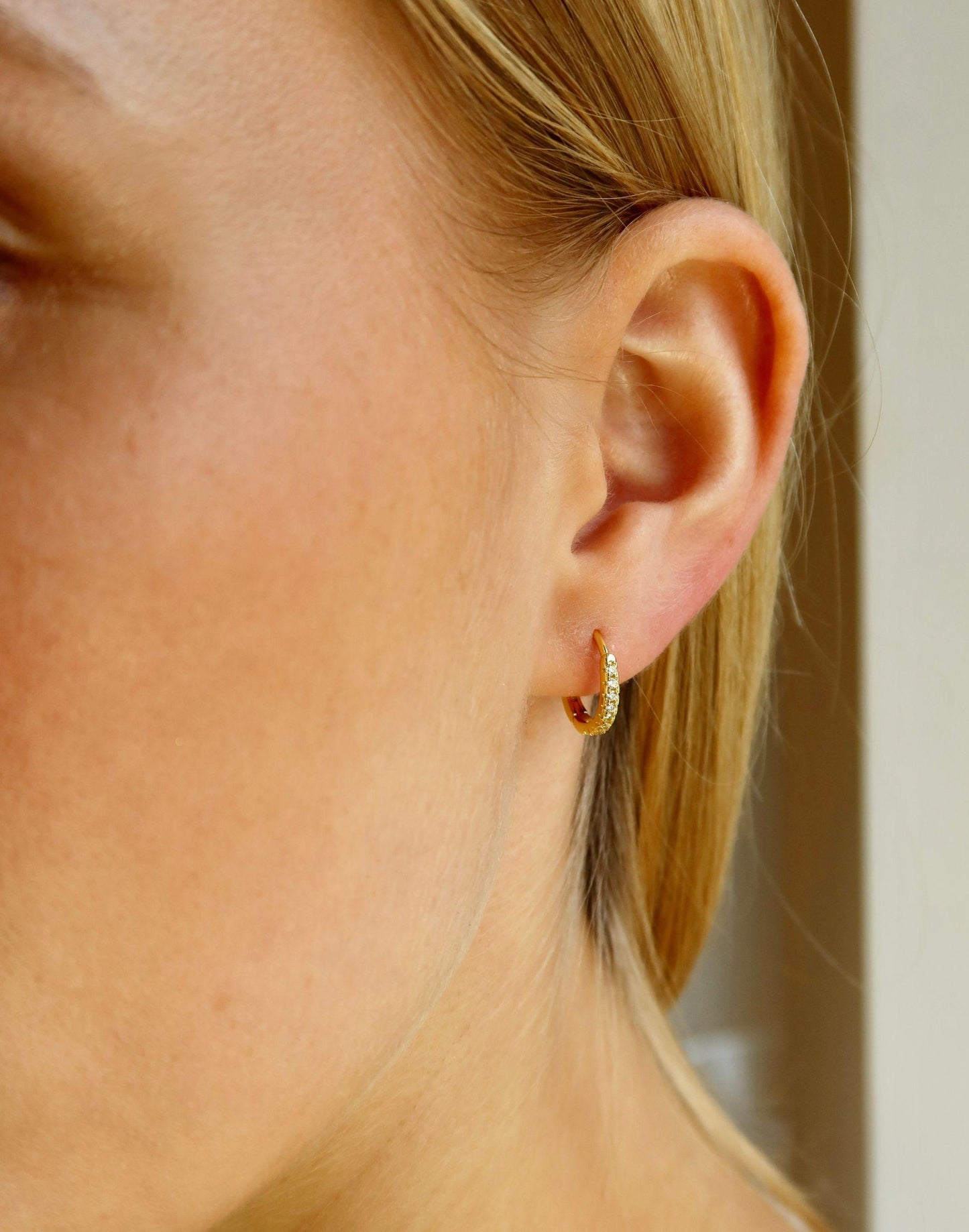 model wears vicky huggie earrings