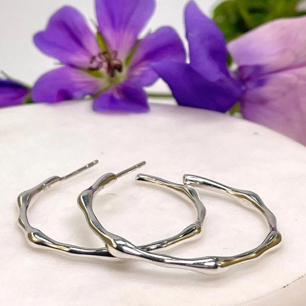 
                  
                    Zelda Silver Bamboo Hoop Earrings on tile
                  
                