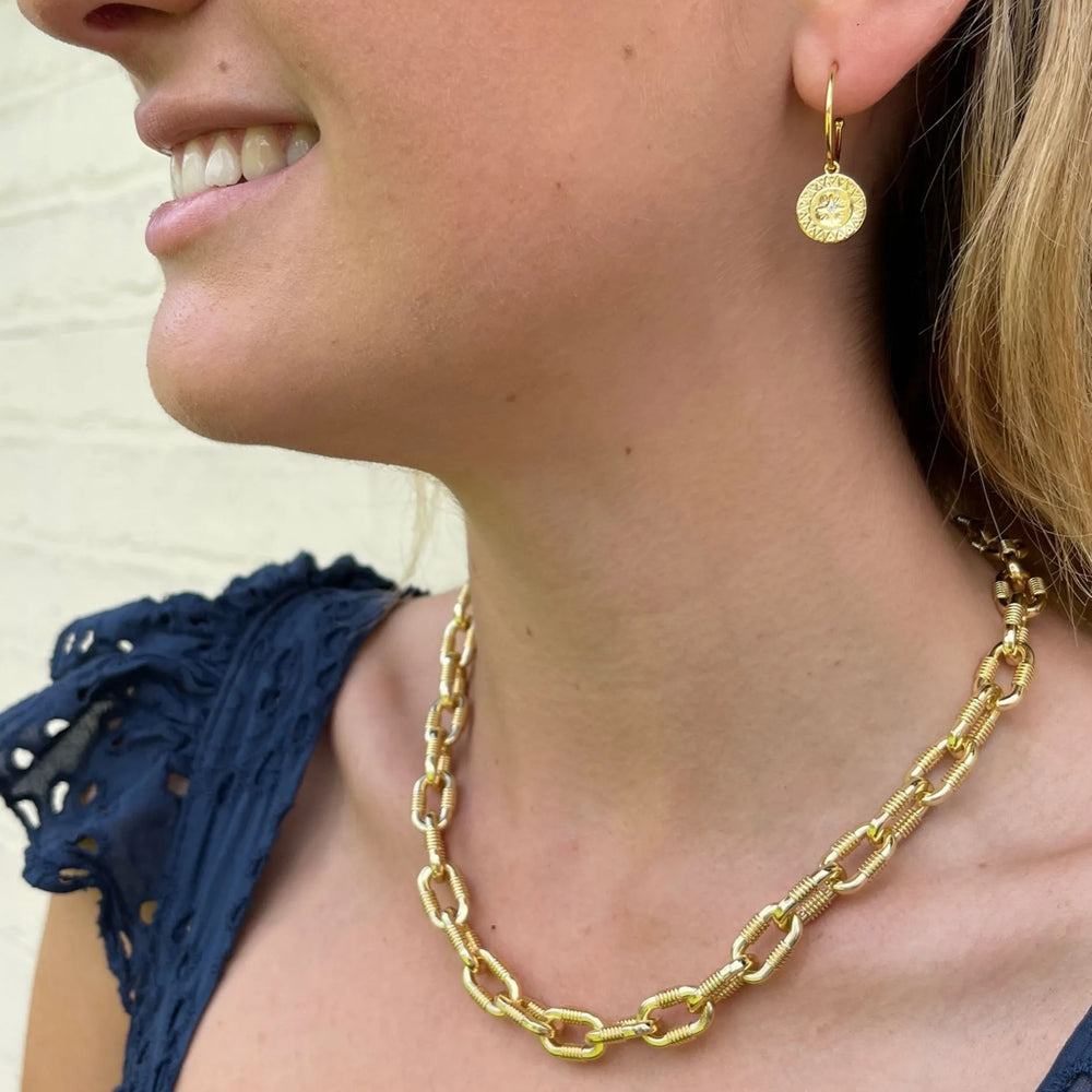 
                  
                    model wears cleo gold hoop earrings
                  
                