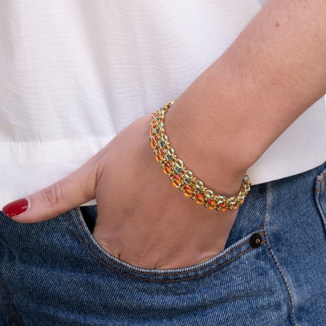 All 4 colours of enamel bracelets on a wrist