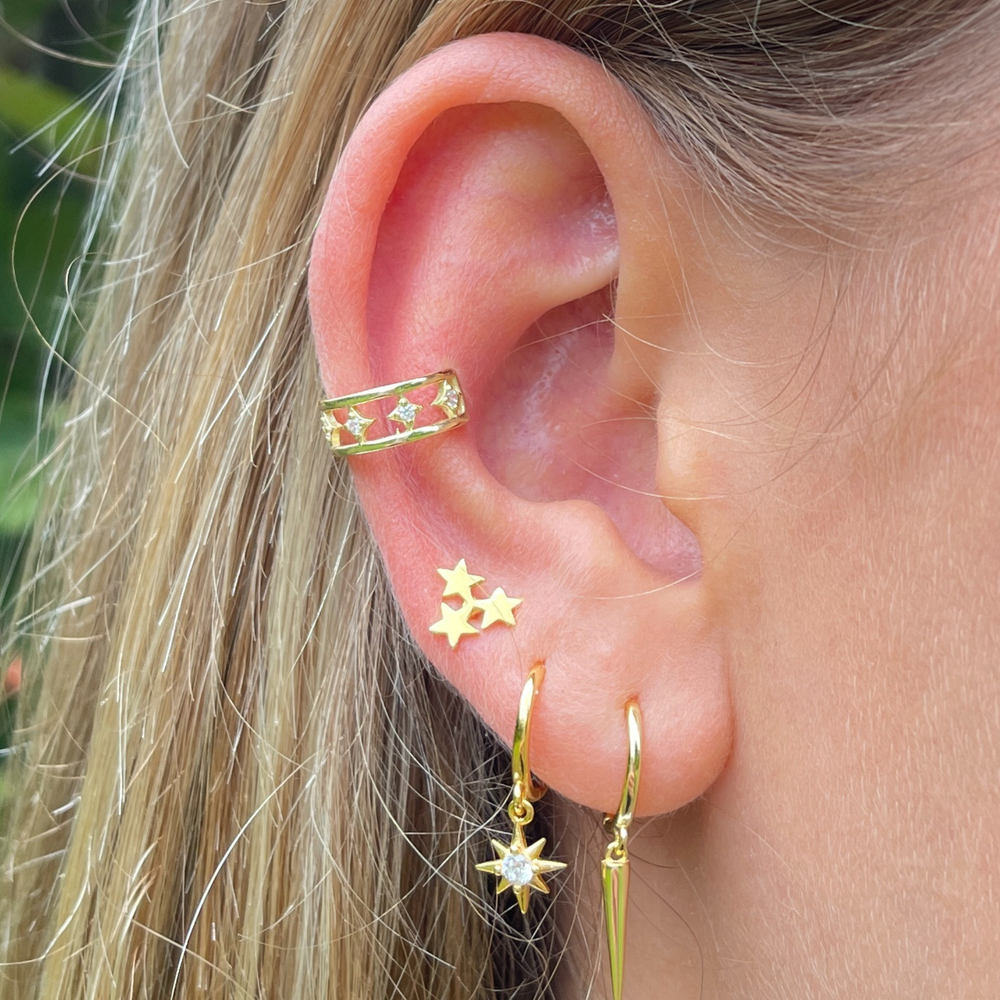 close up of gold huggie and stud earring stack