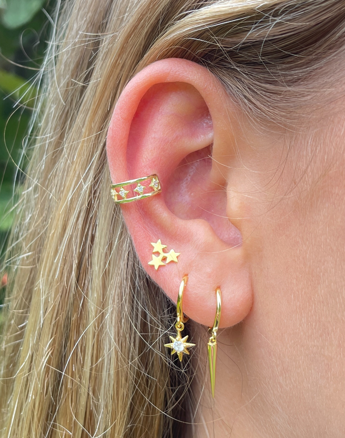 close up of gold huggie and stud earring stack