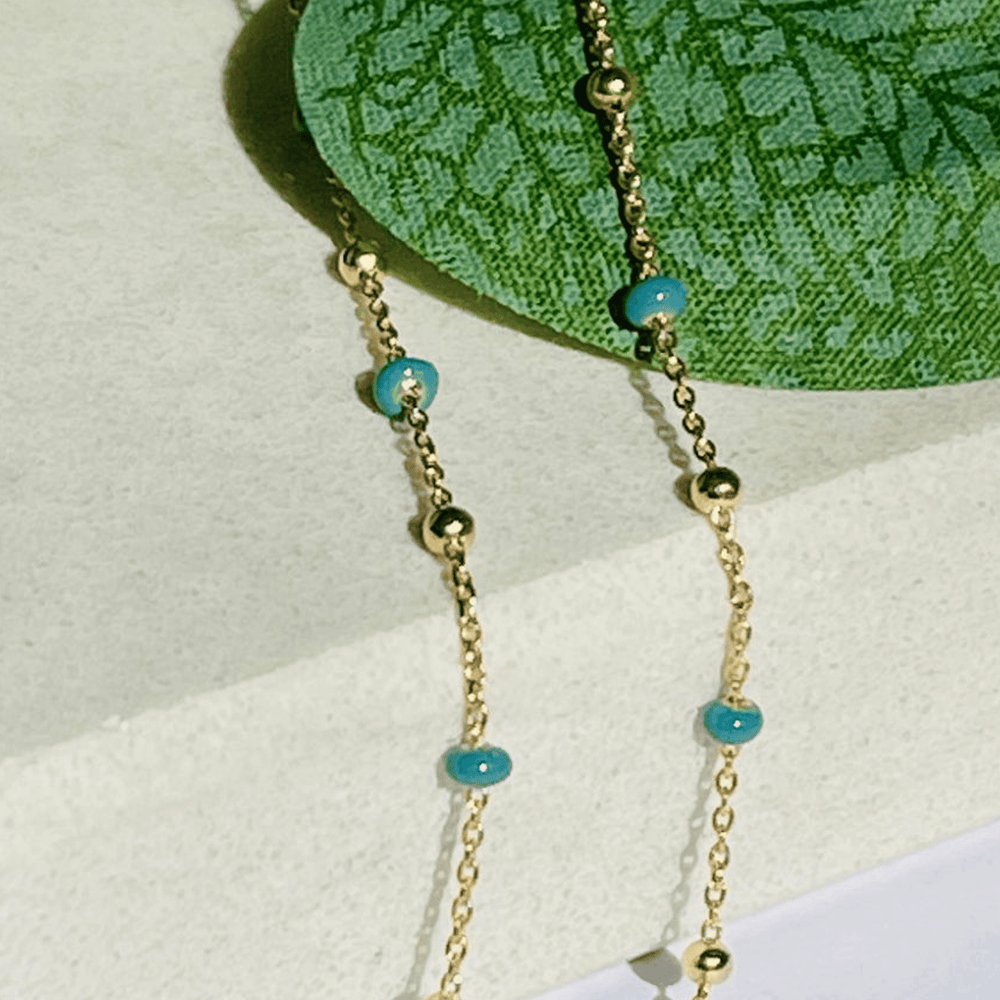 gold dark turquoise necklace close up