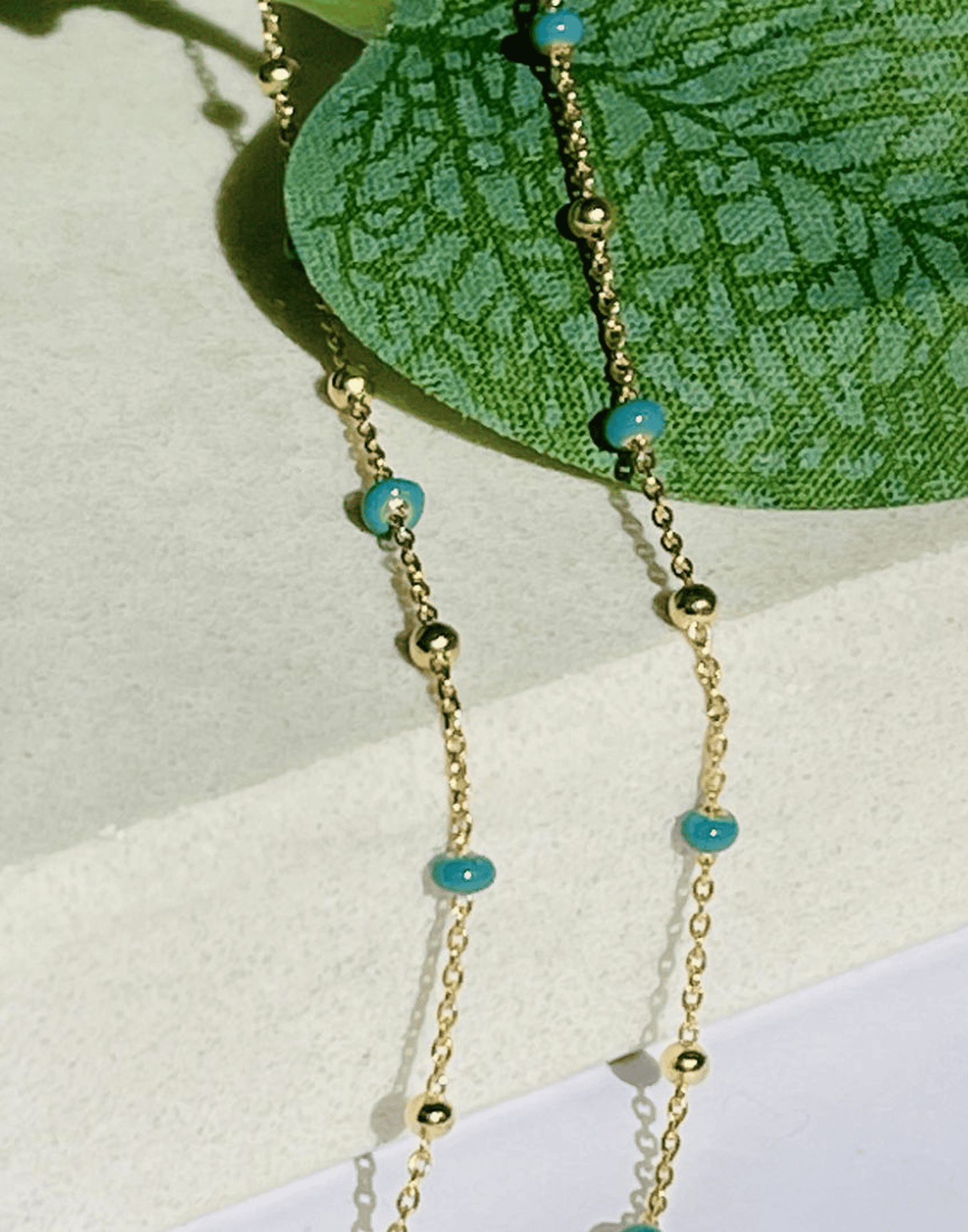 gold dark turquoise necklace close up