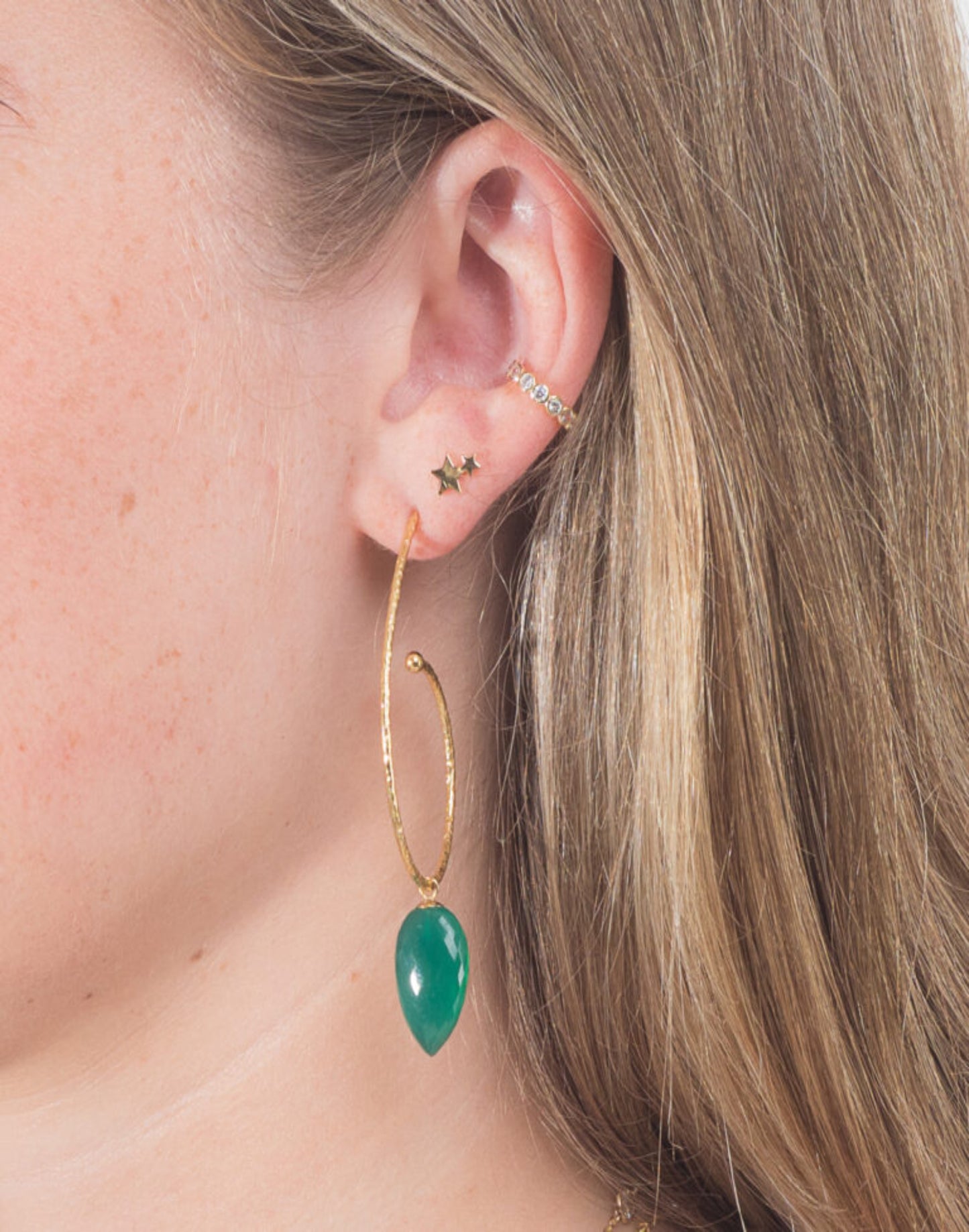 large gold hoop with gree onyx drop in ear