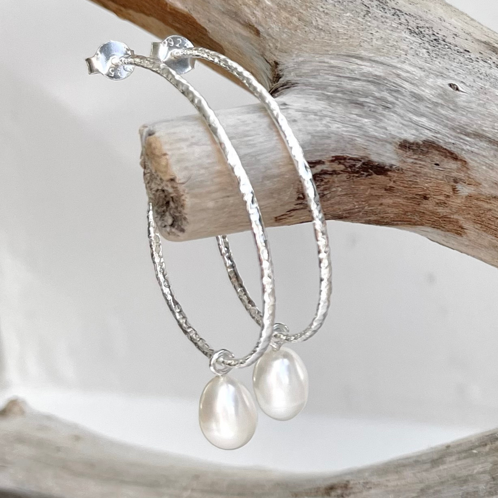 
                  
                    large silver hoop earrings on branch
                  
                